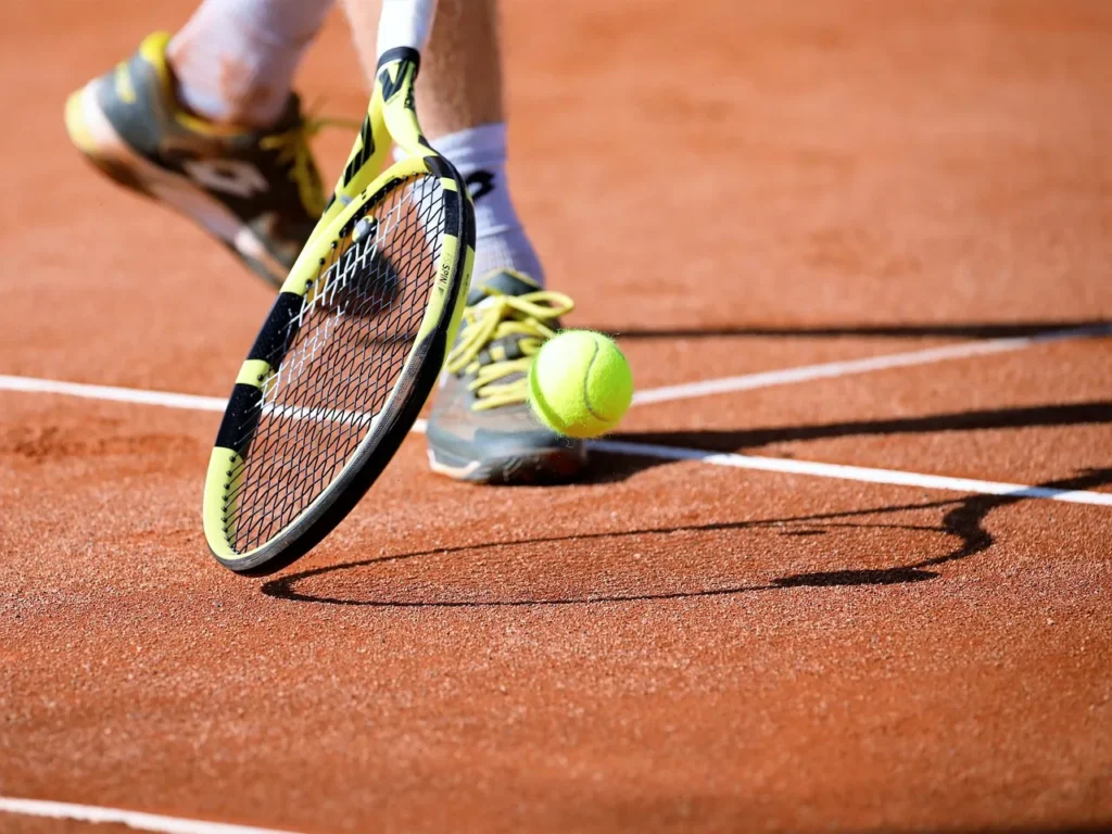 Tennis player trying to hit tennis ball to his opponent