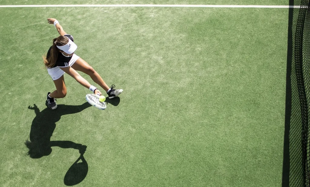 woman swinging tennis racket on the court